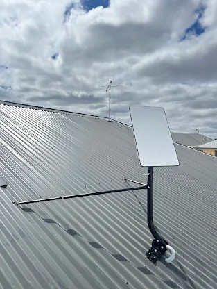 Starlink and TV antenna installation on tin roof