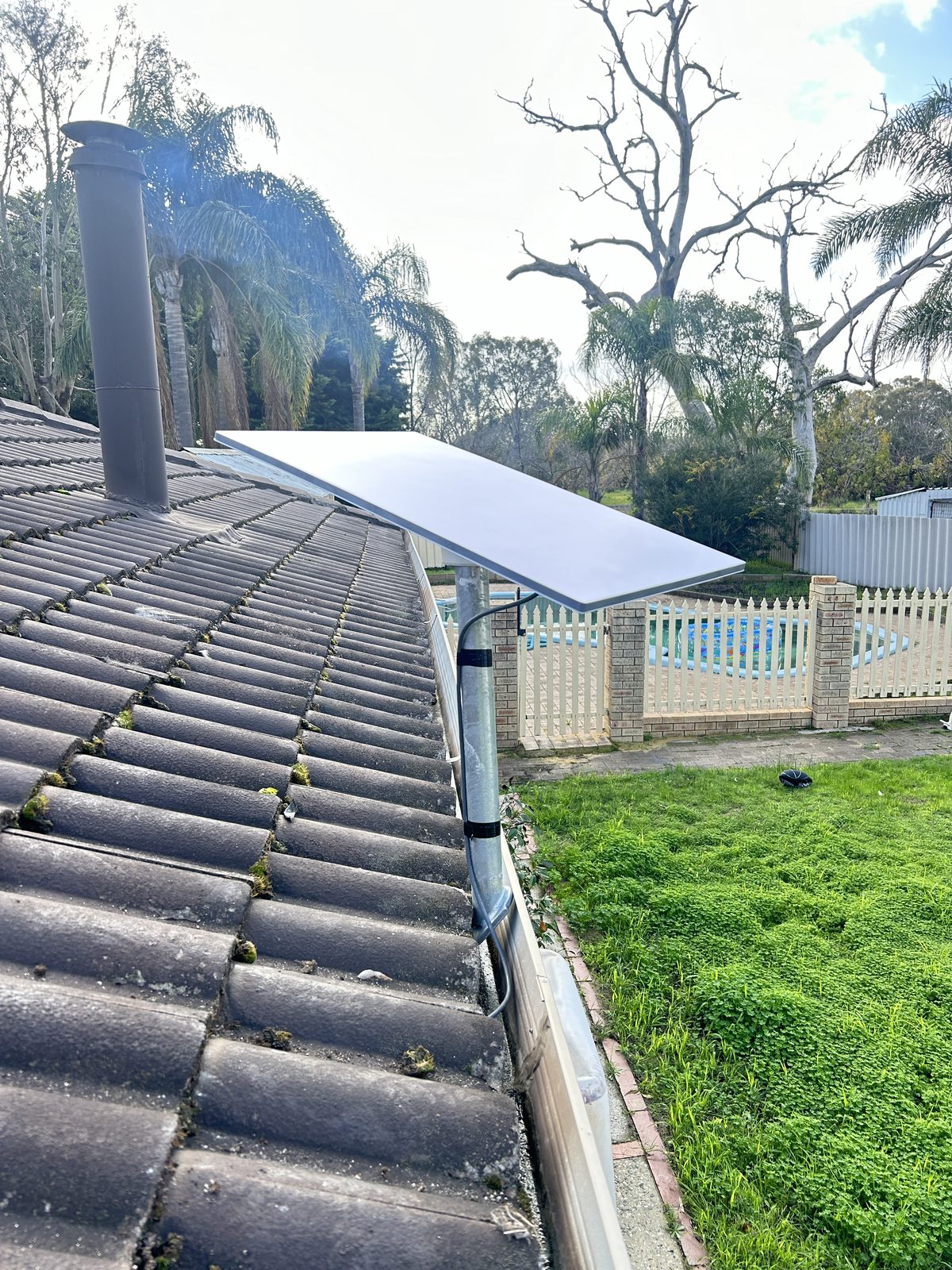 Starlink dish mounted on tile roof, residential property